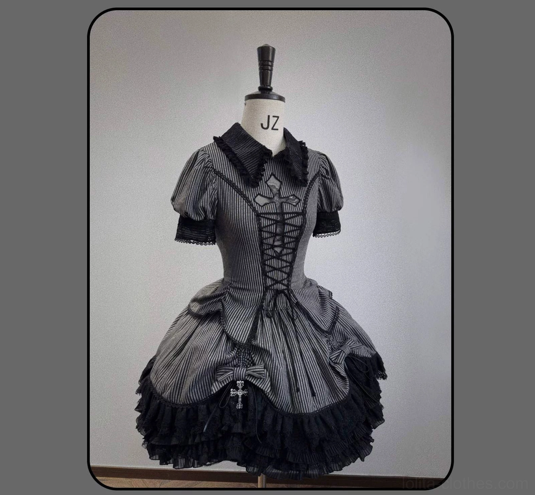 Dark striped Gothic Lolita outfit back view showing blouse and tiered skirt architectural structure