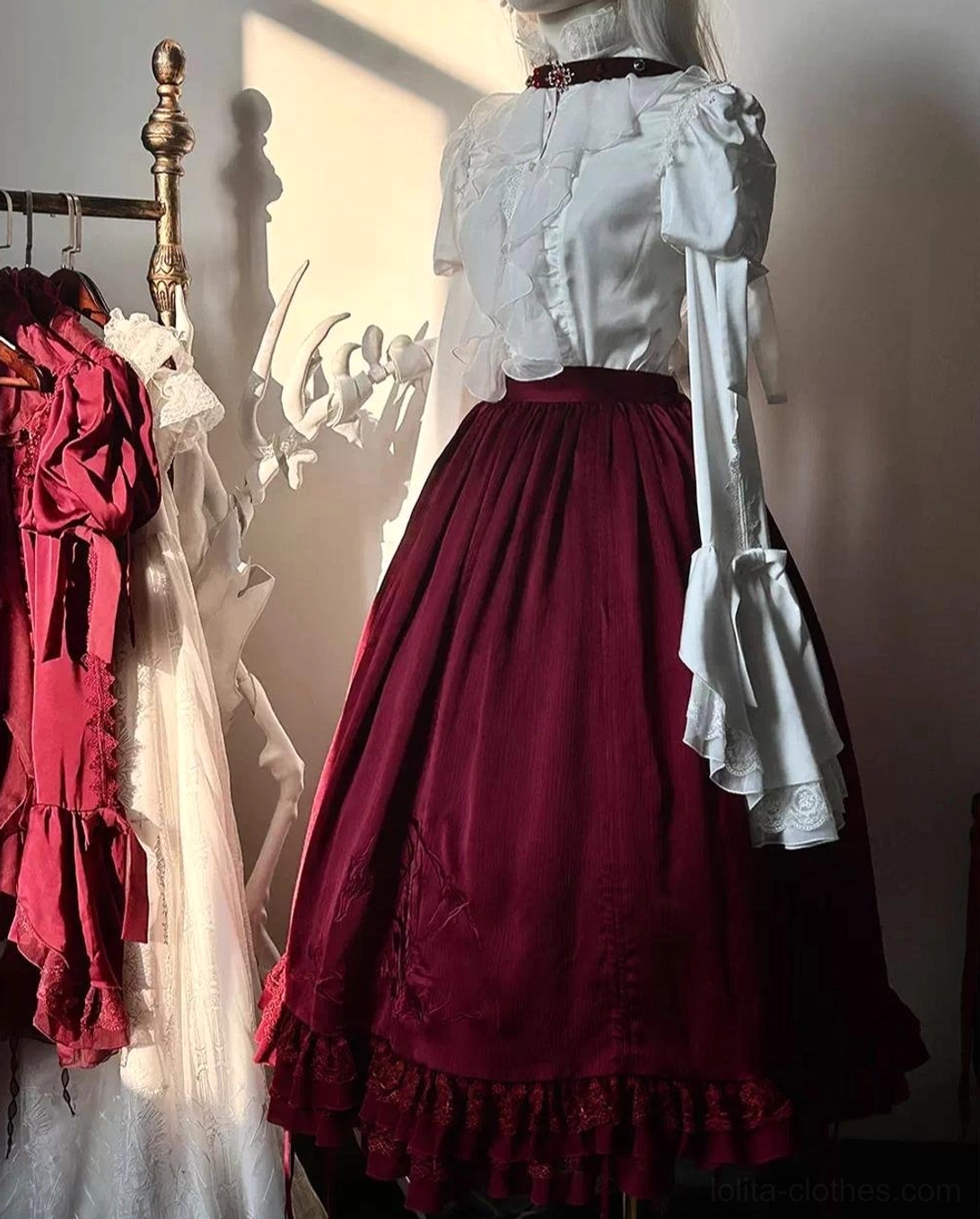 Gothic lolita swallowtail blouse sizing comparison showing garment proportions and drape on mannequin, demonstrating fit across size range