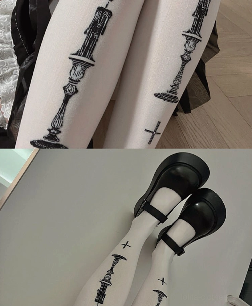 Extreme close-up dual-leg view of Gothic Lolita velvet pantyhose focusing on enlarged clear black candle holder and cross print patterns on soft white velvet base
