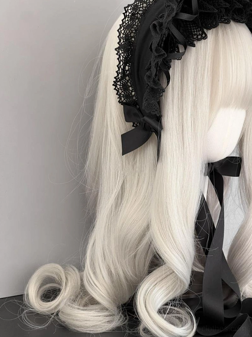 Gothic lolita vintage lace bonnet left side view showing lace headband base, ruffled brim, satin bow at nape, long chin tie straps