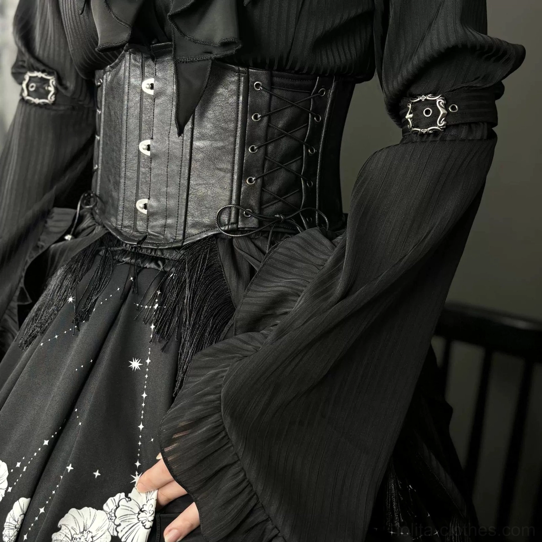 Gothic Lolita corset worn on model torso showing front button rows and lace-up design with ruffled long sleeve blouse and brooch