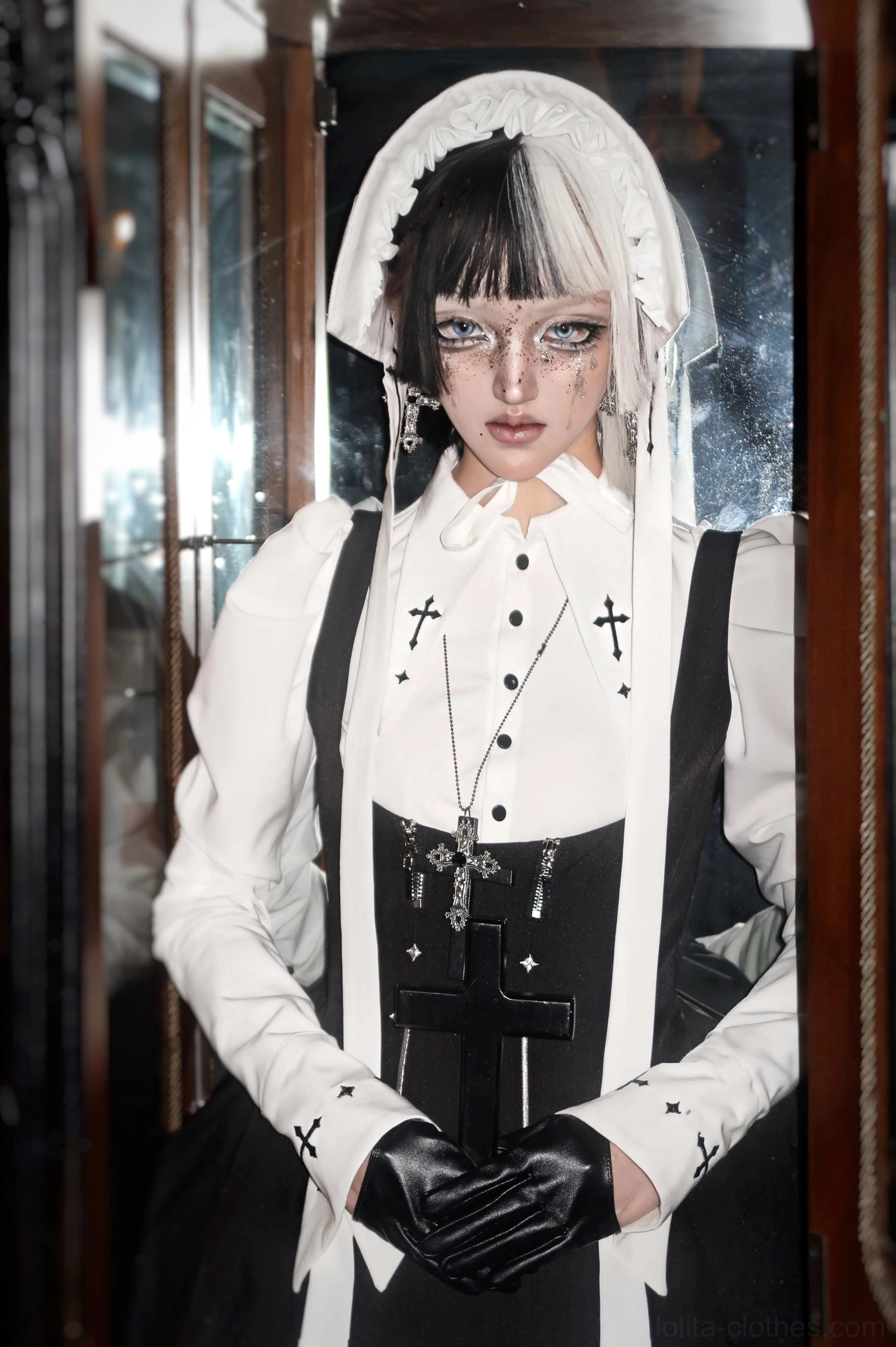 Gothic lolita puff-sleeve blouse with white color, pointed collar, cross embroidery at neckline and cuffs, and decorative buttons