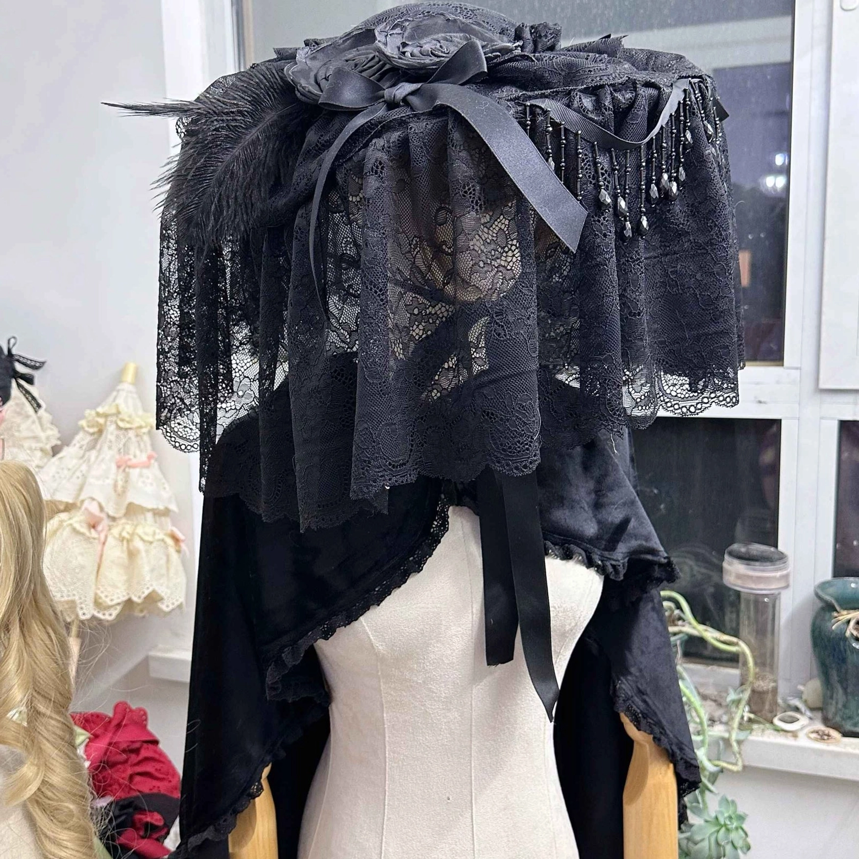 Gothic Lolita widow hat headdress with black lace veil and feather trims displayed on mannequin torso