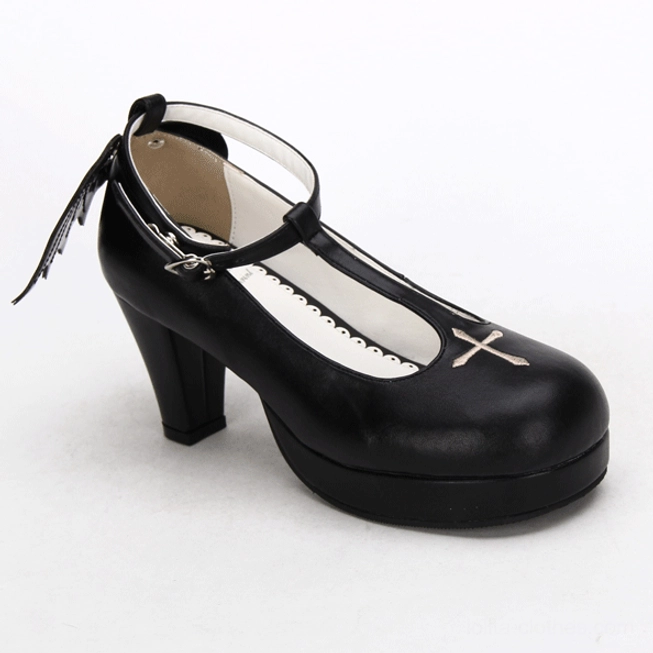 Single Gothic Lolita winged high heel shoe product shot, three-quarter side angle, black leather upper with T-strap ankle buckle, white toe cross detail, black wing charm attached