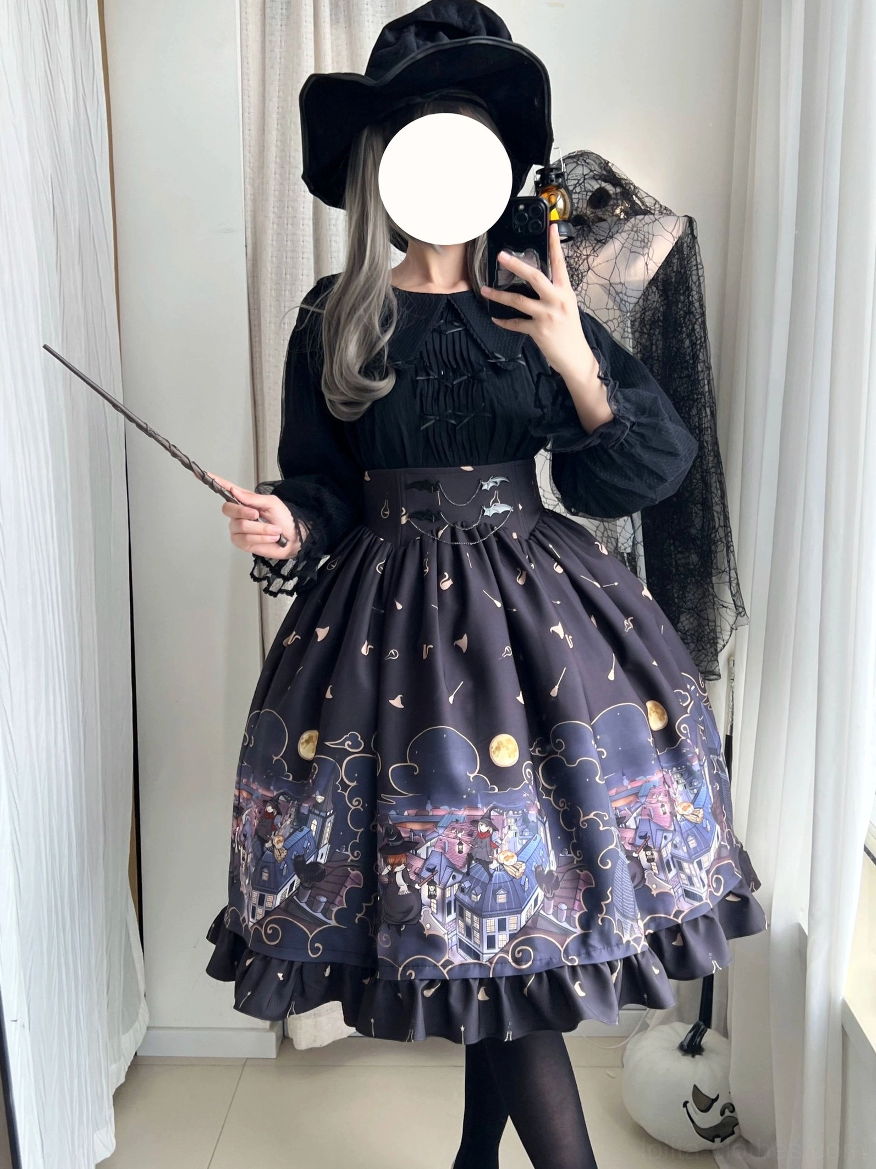 Model wearing dark purple Gothic Lolita Halloween SK skirt with celestial and witch town prints matched with black blouse and fishnet stockings side mirror view