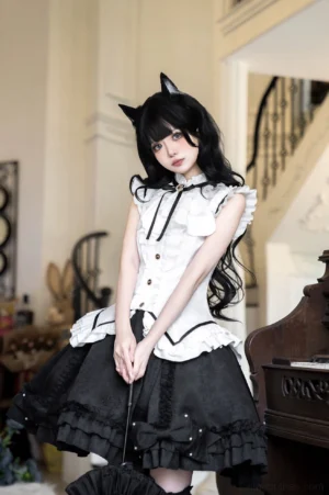 Gothic maid lolita two-piece outfit half-body front view showcasing sleeveless ruffled white blouse with vintage buttons, layered ruffled black skirt with delicate bead decorations, cat ear hair accessory