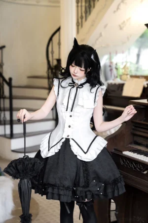 Gothic maid lolita skirt set full three-quarter front view on female model wearing black cat ear hair ornaments, slim fit ruffled blouse paired with multi-layered black skirt, vintage indoor piano setting