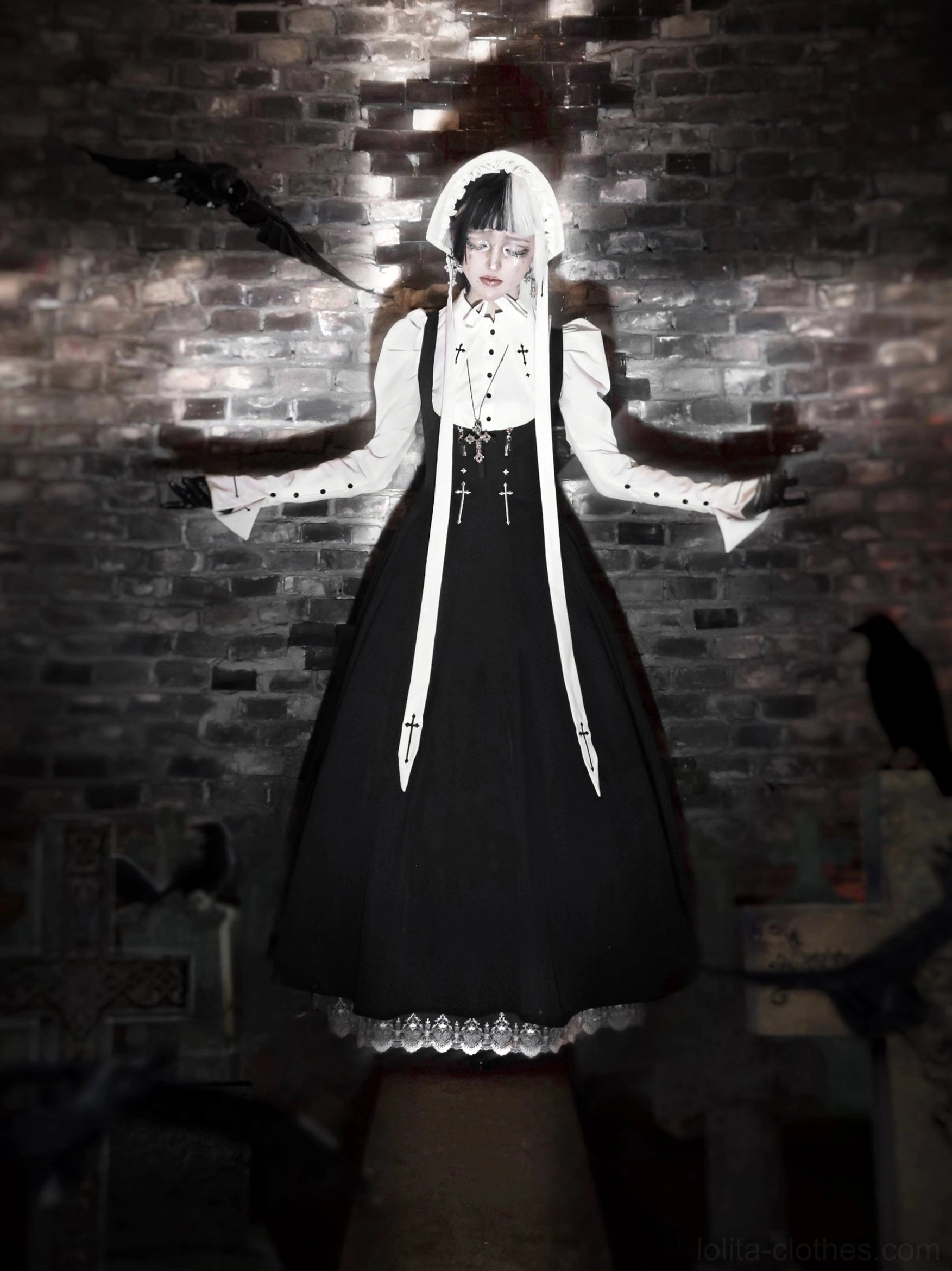 Gothic nun lolita full outfit in dark vintage brick room with crow decorations, black JSK with lace hem trim and cross-embroidered sashes