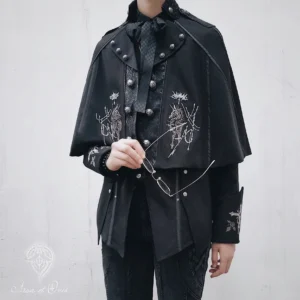 Gothic Ouji Lolita short black embroidered cape with silver knight motif front half-body view on androgynous male model, metal stud shoulder decorations and button detailing