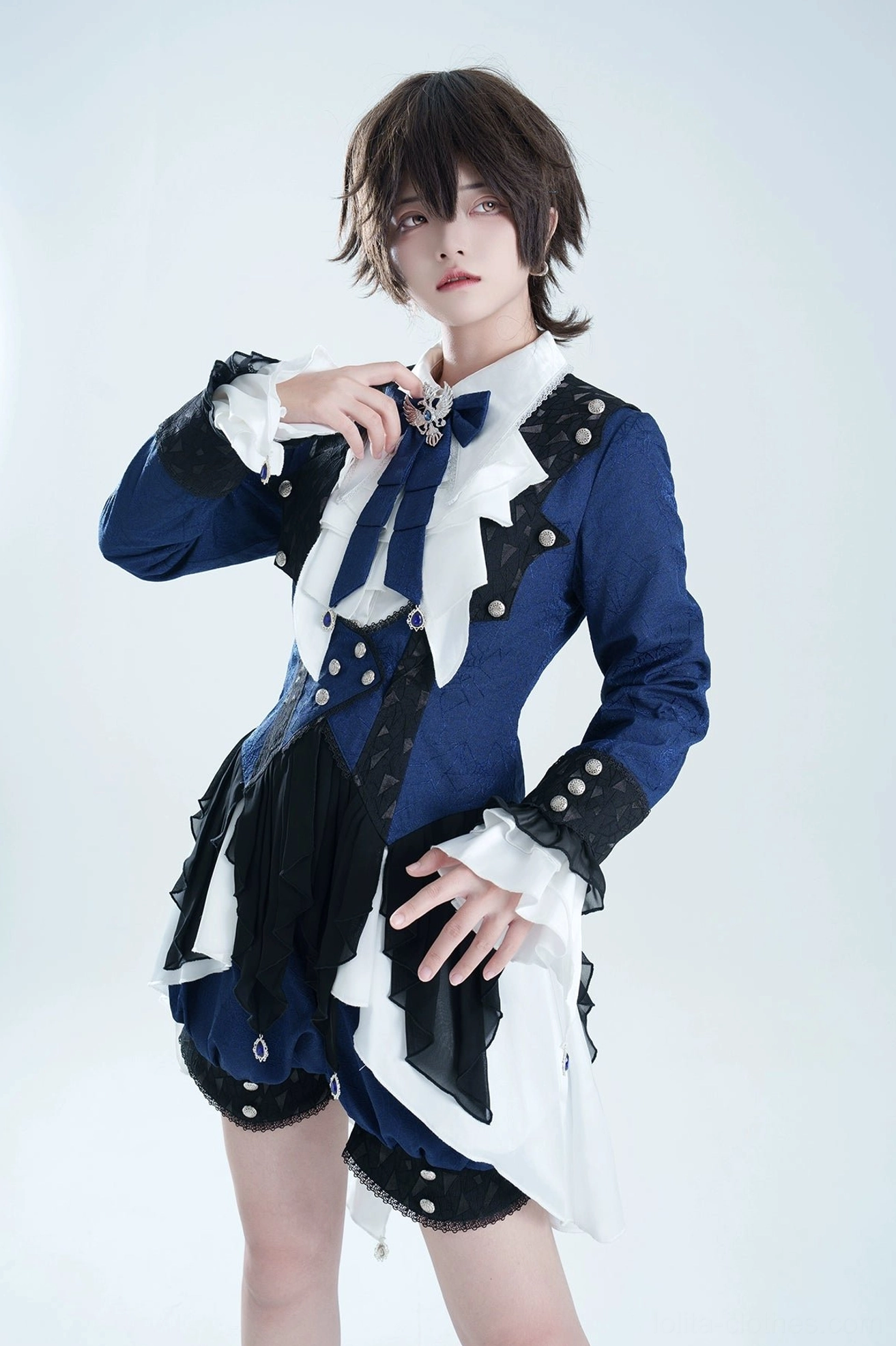 Ouji lolita coat set front view worn by model showing bat-wing collar asymmetrical hem dark blue black white gothic ensemble
