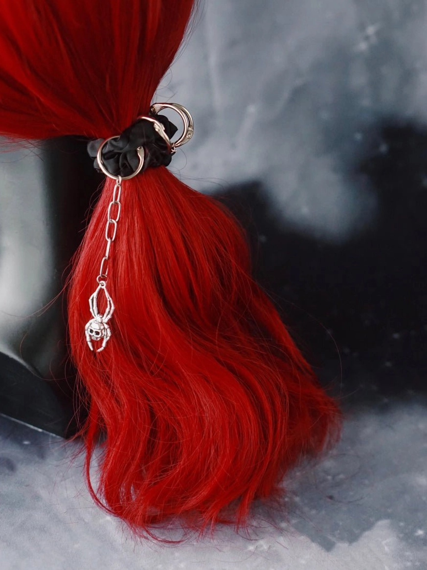 Gothic ponytail hairband with dangling skull drop chain on red synthetic hair mannequin