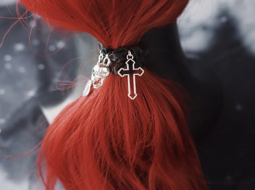 Gothic black skull chain hairband front view showing pendant arrangement and satin finish