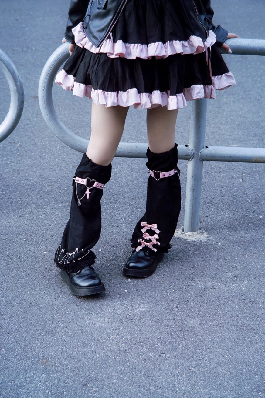Full product showcase of gothic suede leg warmers pair displaying both black and pink elements suede texture metal accents heart buckle cross pendants lolita accessory