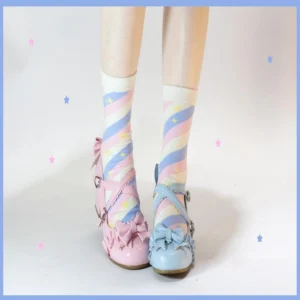 Close-up low-angle view of striped lolita mid-calf socks on model's lower legs and feet with tiny star studio backdrop details paired with bow-adorned Mary Jane shoes