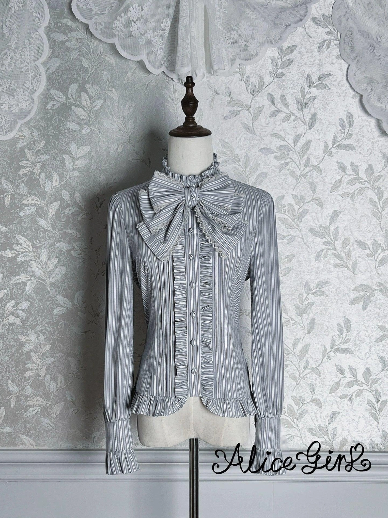 Gray-blue striped Victorian lolita blouse front view with detachable bow and ruffled collar on dress mannequin