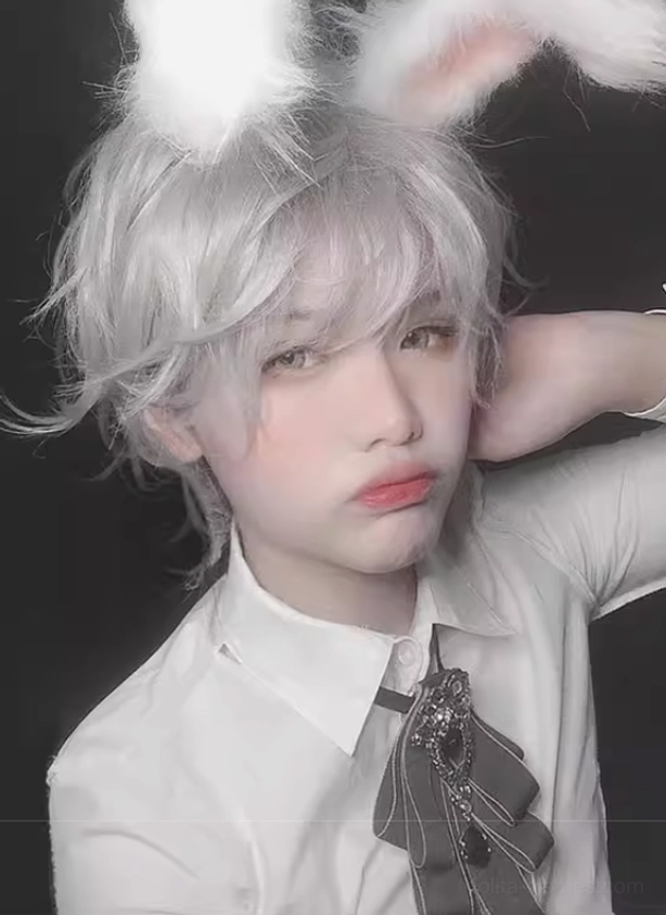 Eye-level view of messy short curly silver gray wig with fluffy rabbit ears and vintage gem brooch neckwear