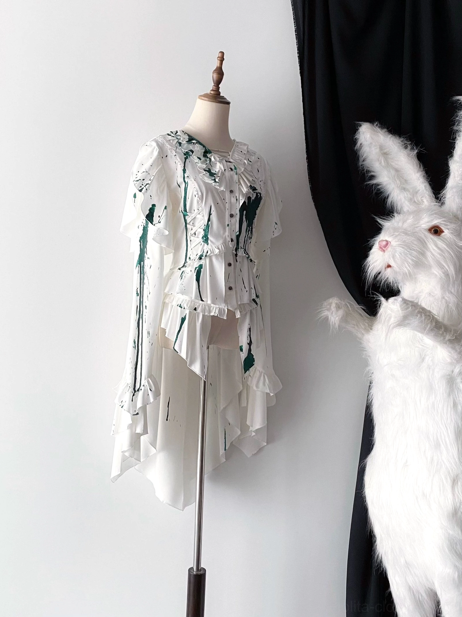 Green blood-stain Ouji lolita trailing blouse with fine silver glitter and emerald-inspired splash pattern on white matte satin, showcasing ruffled front design and irregular asymmetrical hem