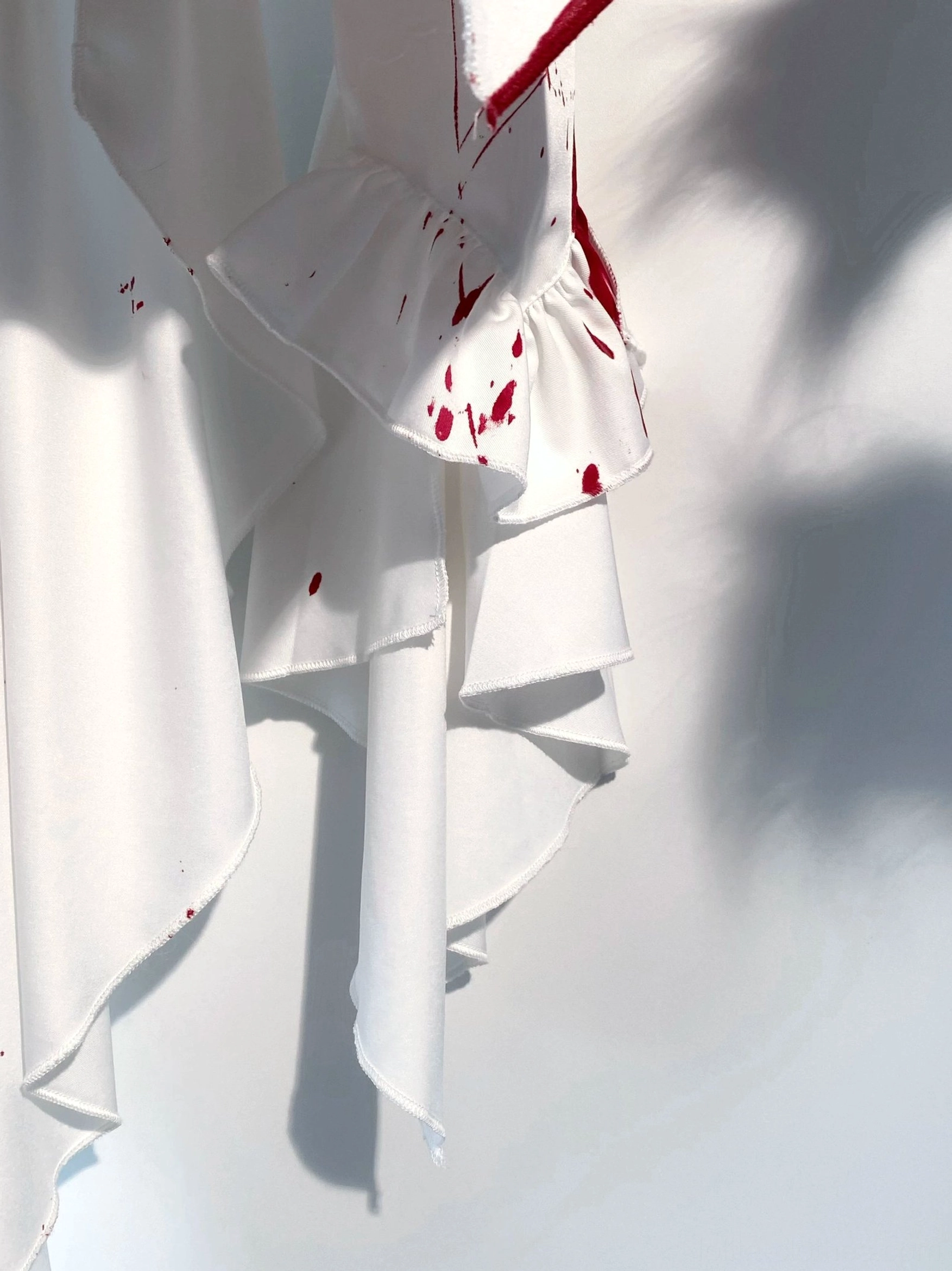 Green blood-stain and blue blood-stain color variants of Ouji lolita blouse displayed side-by-side, showcasing available artistic stain pattern options and color choices