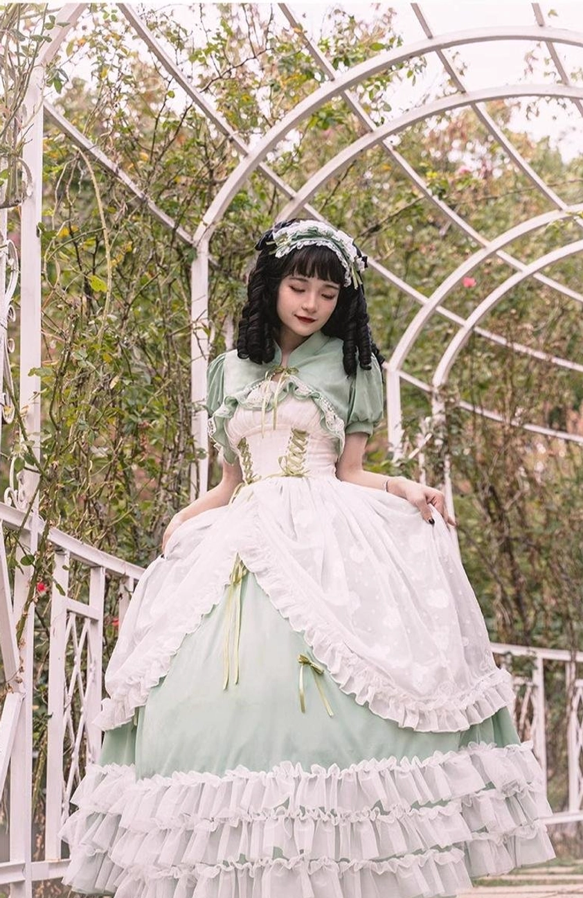 Sage green bridal lolita JSK dress showing full skirt volume, layered petticoat beneath, and graceful A-line silhouette with floor-length hem in sage green tone
