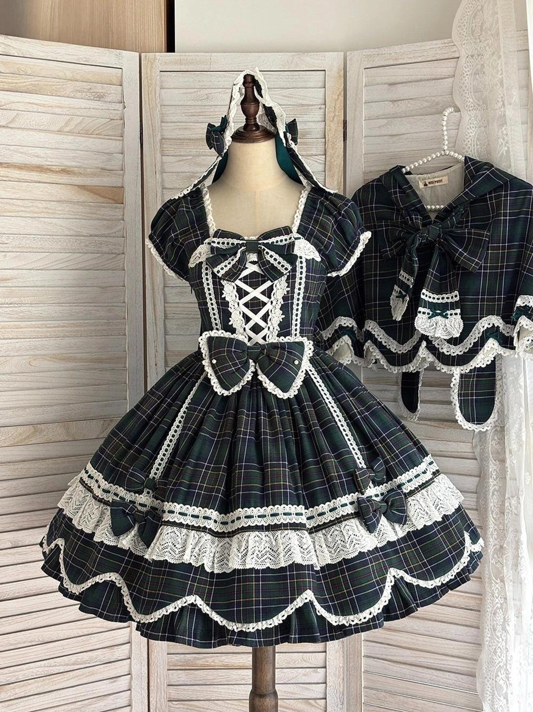 Green-plaid vintage lolita OP dress with petal-shaped hem, pearl-adorned waist bow, square neckline, and classic Old School design elements
