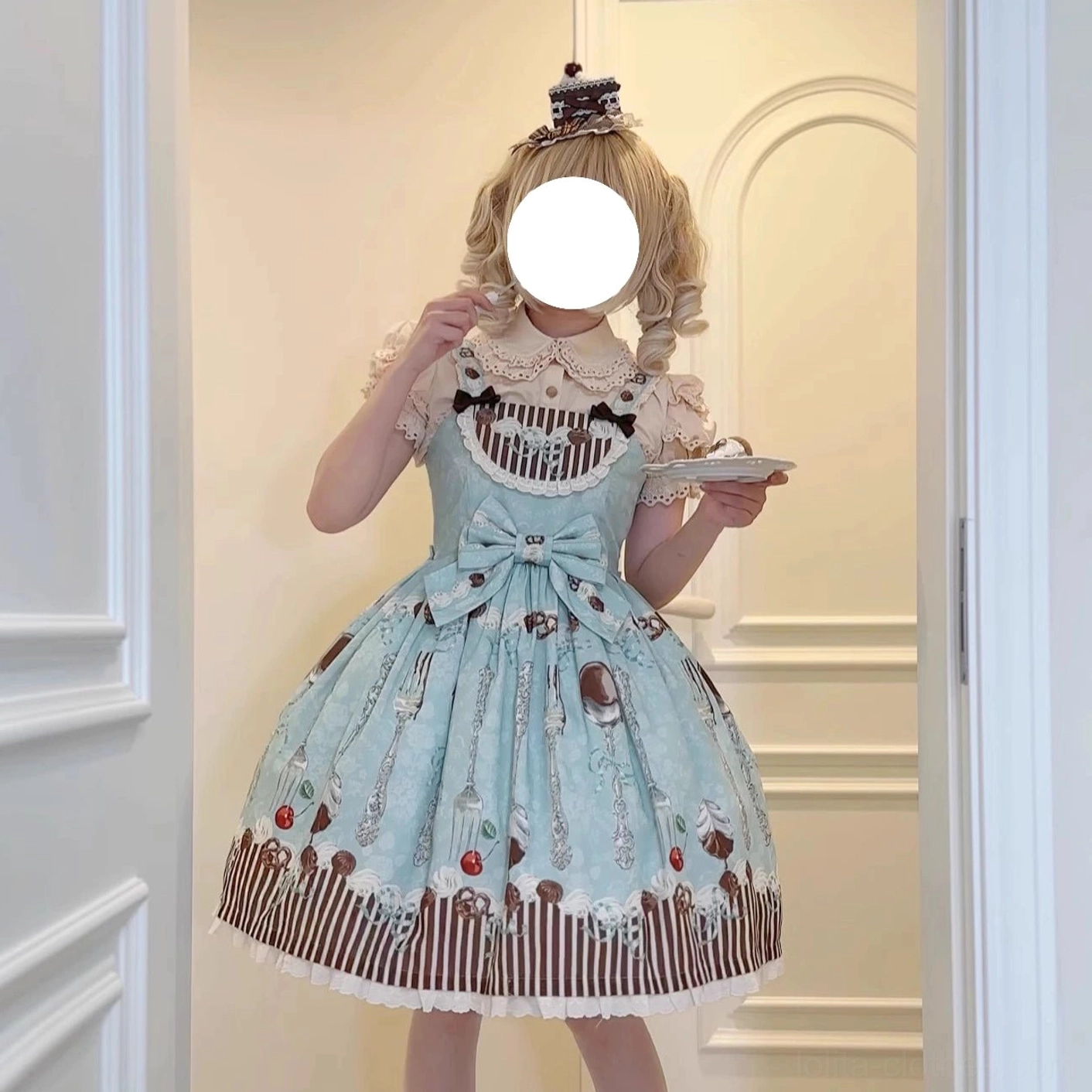 green dessert lolita jumper skirt hem detail with cutlery cherry pattern embellishment close up