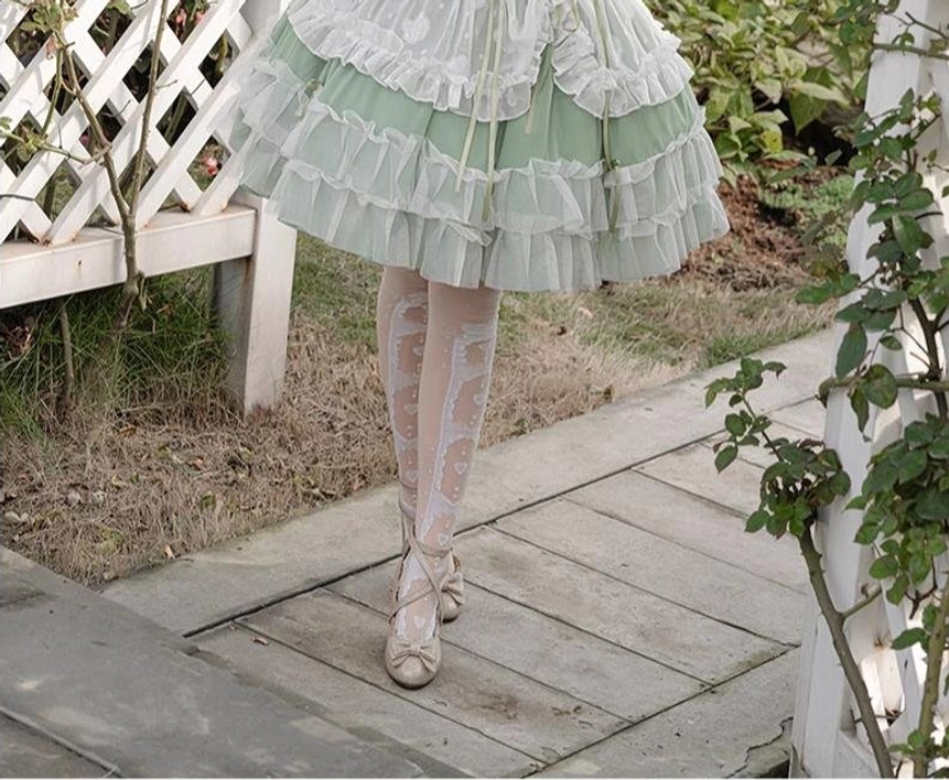Sage green wedding lolita JSK detail highlighting hand-sewn elements, decorative bows, ribbon details, and artisanal craftsmanship quality of bridal dress