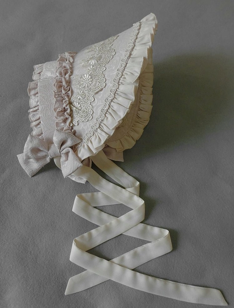 Greige cream ivory Lolita bonnet flat lay with delicate embroidered lace and ruffle trim headdress