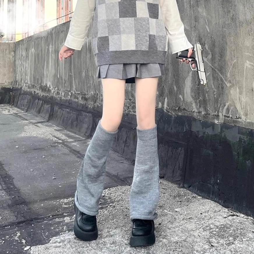 Grey knitted leg warmers for lolita fashion front full body view outdoor rooftop concrete background paired with plaid skirt