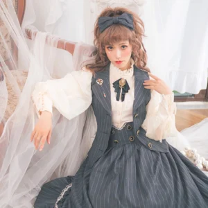 Dark grey pinstriped lolita vest dress with vintage acrylic gemstone buttons, styled indoors with brooch and black bow tie, front medium full-body shot in vintage bedroom setting