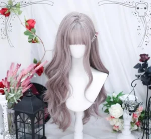 Front angled perspective of grey-purple lolita long curly wig displaying natural wavy texture and full blunt bangs with small side hair clip on half-body white mannequin with romantic retro props