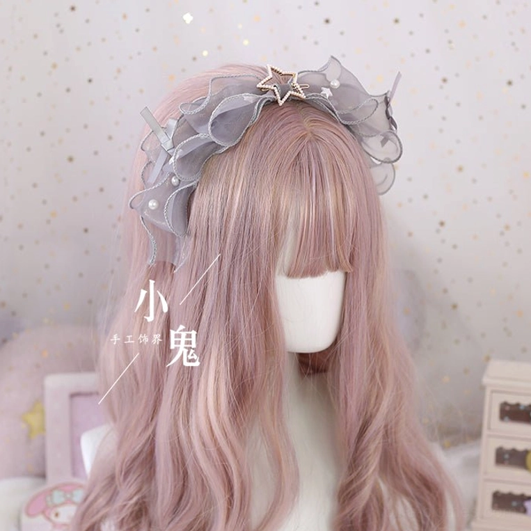 Grey lolita bow hair clip with star metal ornament and pearl embellished mesh on mannequin with pink curly hair