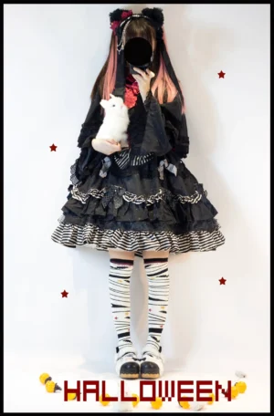 Black and white striped Halloween Lolita knee-high socks with star embellishments on full body model wearing Gothic Lolita dress holding white plush rabbit
