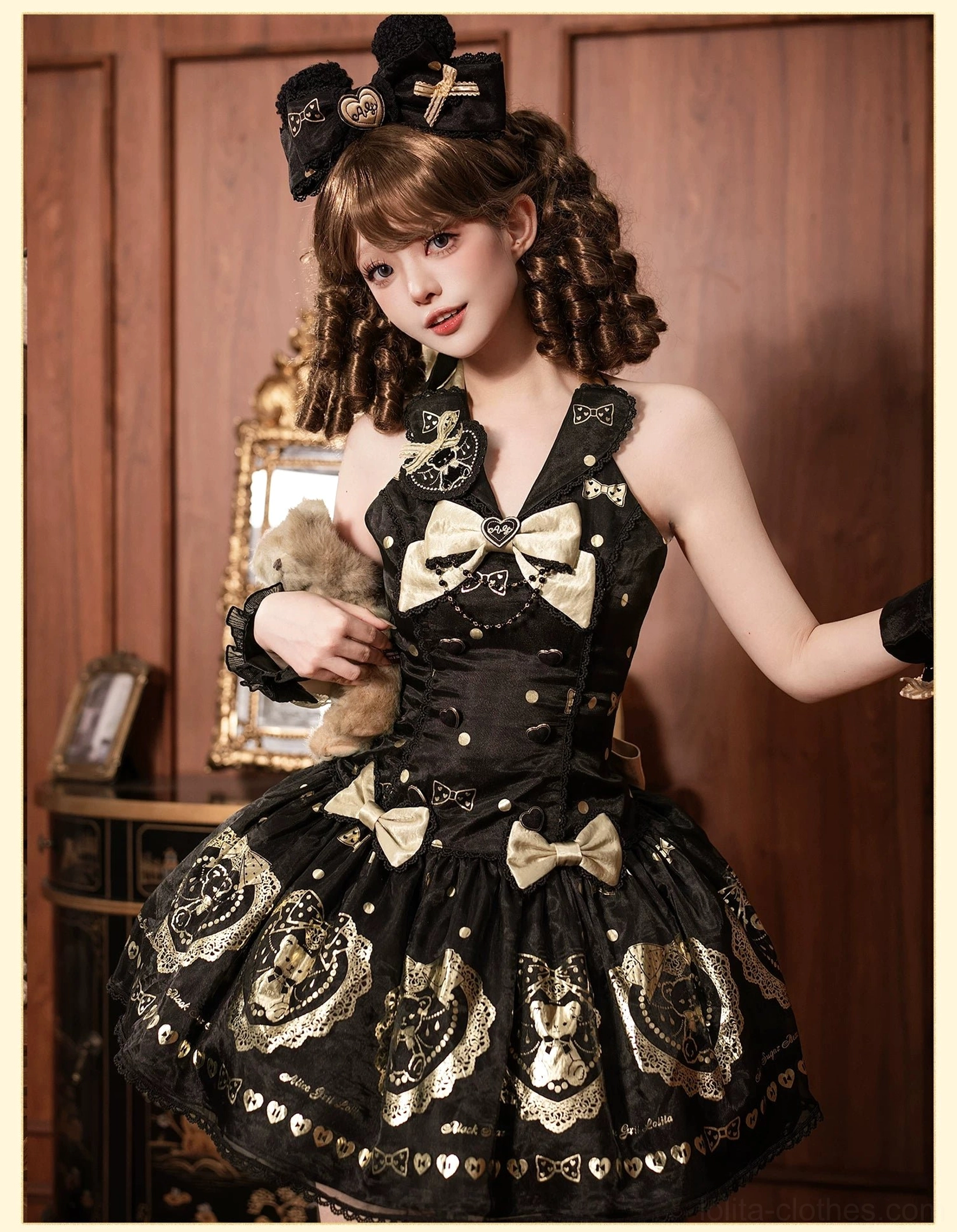 Three-quarter view of black and gold bear print halter lolita dress on dress form, emphasizing silhouette proportions, skirt flare, and overall old school lolita aesthetic composition