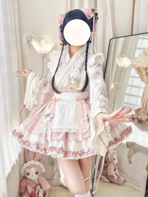 Three-quarter half-body front close-up of Han Lolita blouse showcasing cross-collar neckline, floral embroidery details, ruffled placket accents, bishop-style flared sleeves, and pink ribbon decorations with traditional Chinese hairstyle styling