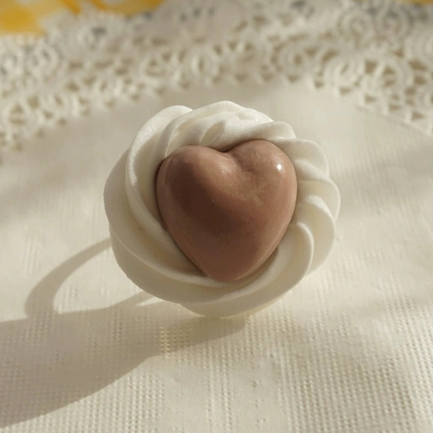 Coffee brown handmade cream heart adjustable Lolita ring close-up with white sculpted cream effect frame