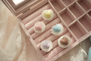 Five color handmade cream heart adjustable Lolita statement rings arranged on pink jewelry box and lace background