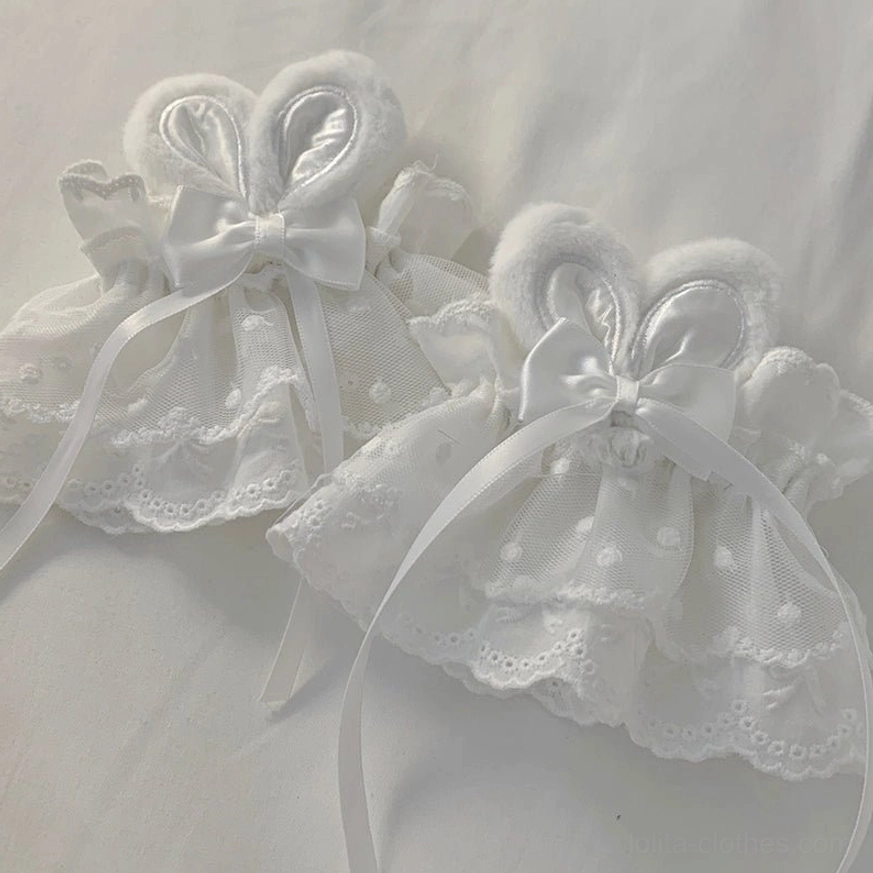 Handmade rabbit ear lace wrist cuffs detail shot showing lace texture satin bow construction artisan quality