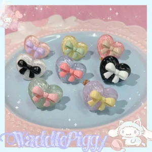 Handmade Sweet Lolita adjustable heart bow rings in eight pastel and monochrome color styles on a pink sparkly background