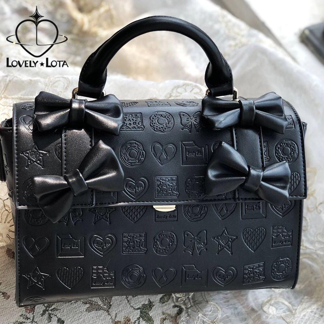 Black heart embossed chocolate Lolita bow handbag with four bows and curved top handle