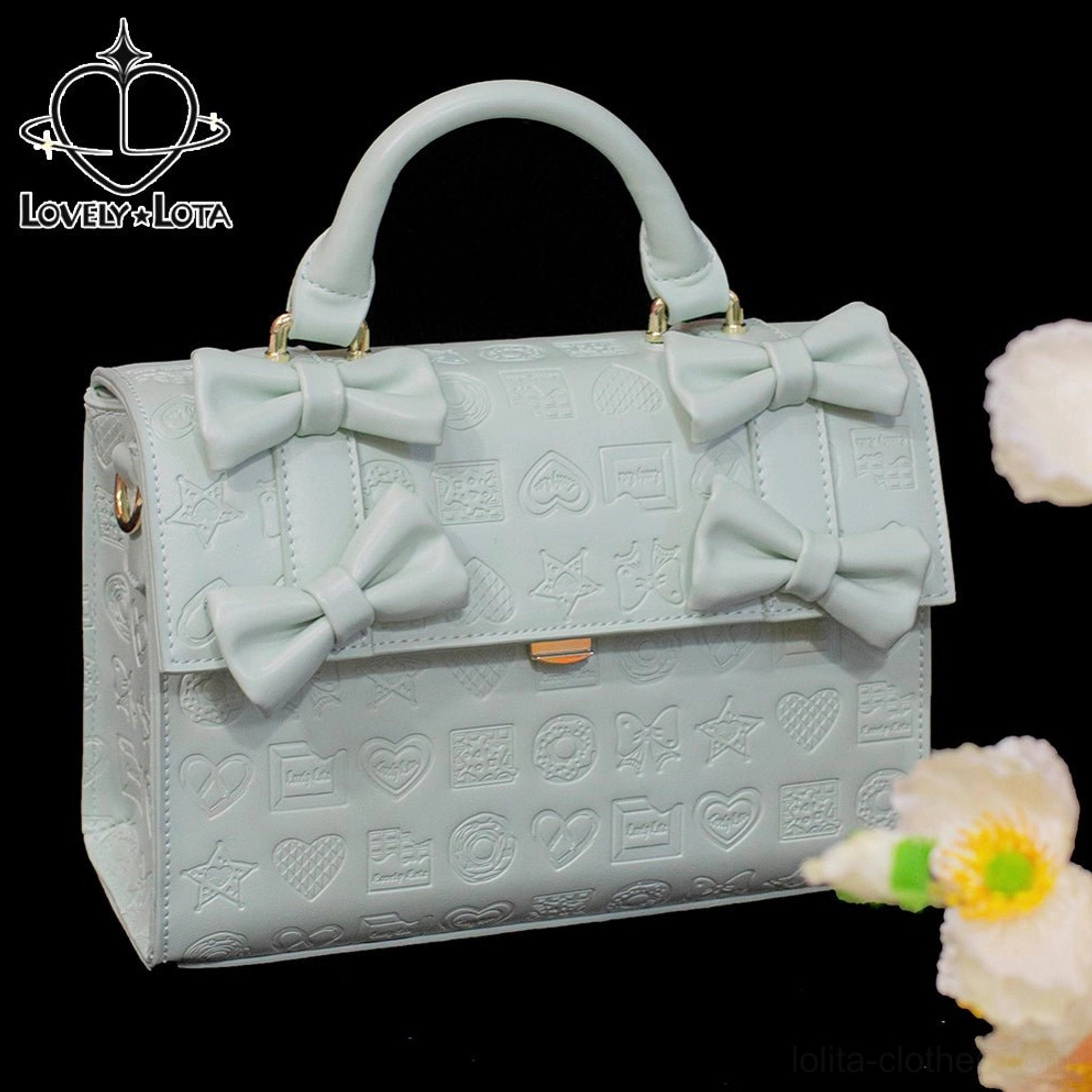 Mint green heart embossed chocolate Lolita bow handbag with gold tone clasp and front bows