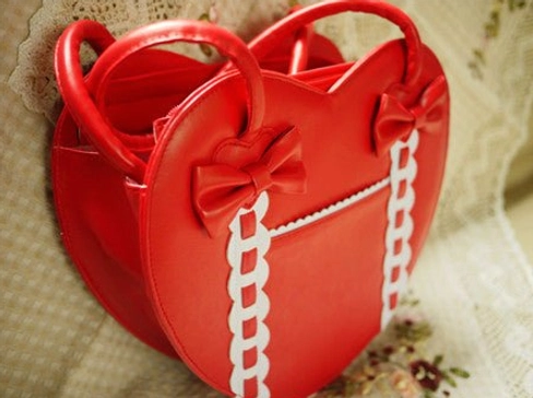 Heart-shaped Lolita tote bag side profile view showing silhouette shape and handle construction