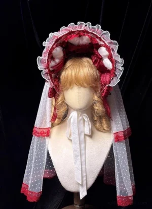 Wine red sweet lolita bonnet with polka-dot tulle veil and white pom-pom embellishments front view