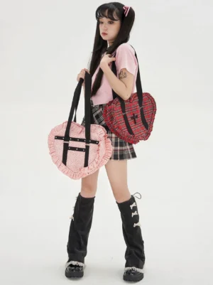 Heart-shaped Lolita JK uniform tote bag front view with pink polka dot and red tartan colorways worn by model in Y2K Lolita coordinate