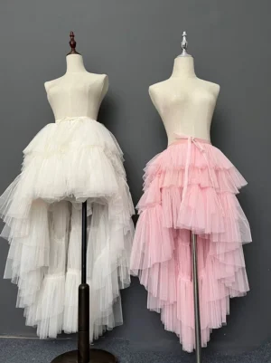 Front eye-level view of high-low layered tulle Lolita skirt in off-white and pink color options displayed on dress forms showing multi-layered cake-style tulle construction with asymmetrical train hem