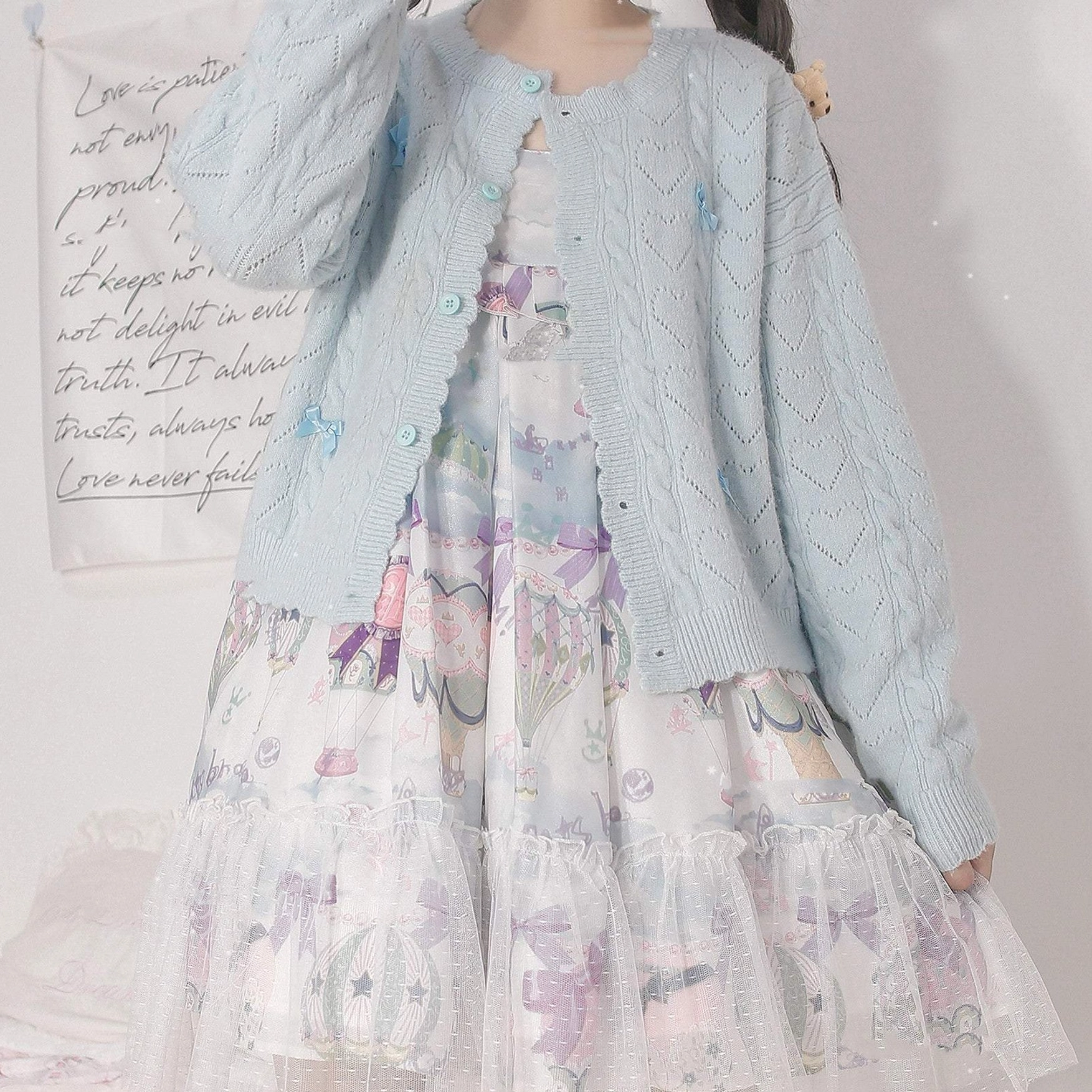 Hollow out Lolita cardigan front view showing round neckline, non-removable bow details, and spreading bow embellishments on long sleeves