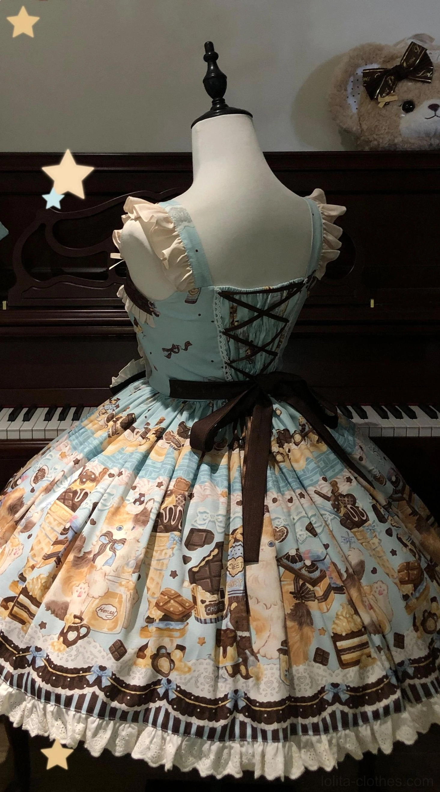 Back view of mint Honey Chocolate Lolita JSK dress showing lace-up back closure, long brown waist sash, frilled skirt hem with chocolate dessert allover print, and structured lolita silhouette