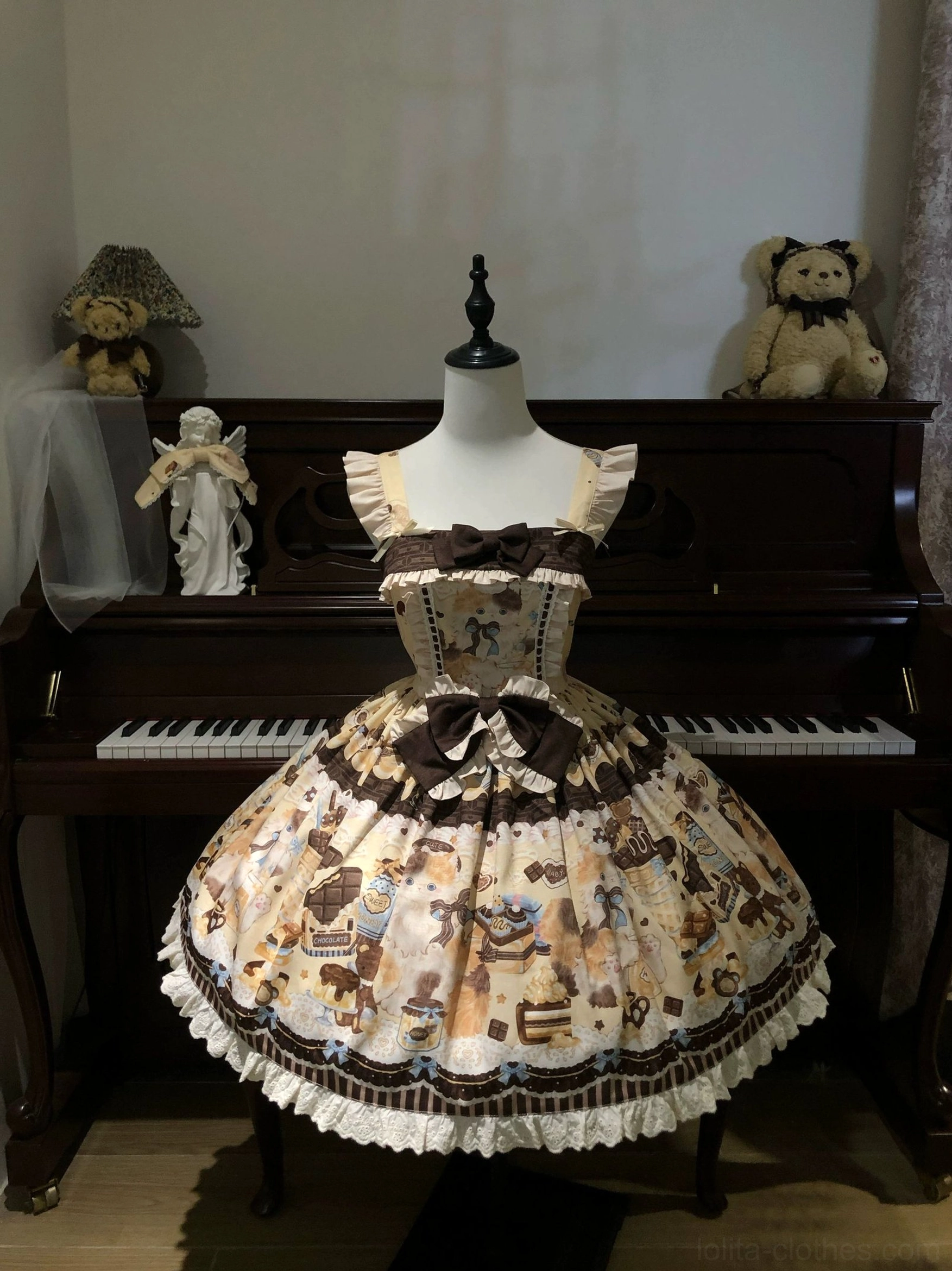Khaki yellow Honey Chocolate Lolita JSK dress displayed on mannequin in piano studio, showing brown chocolate print, ruffled lace trim, decorative waist bow, and classic sweet lolita design details
