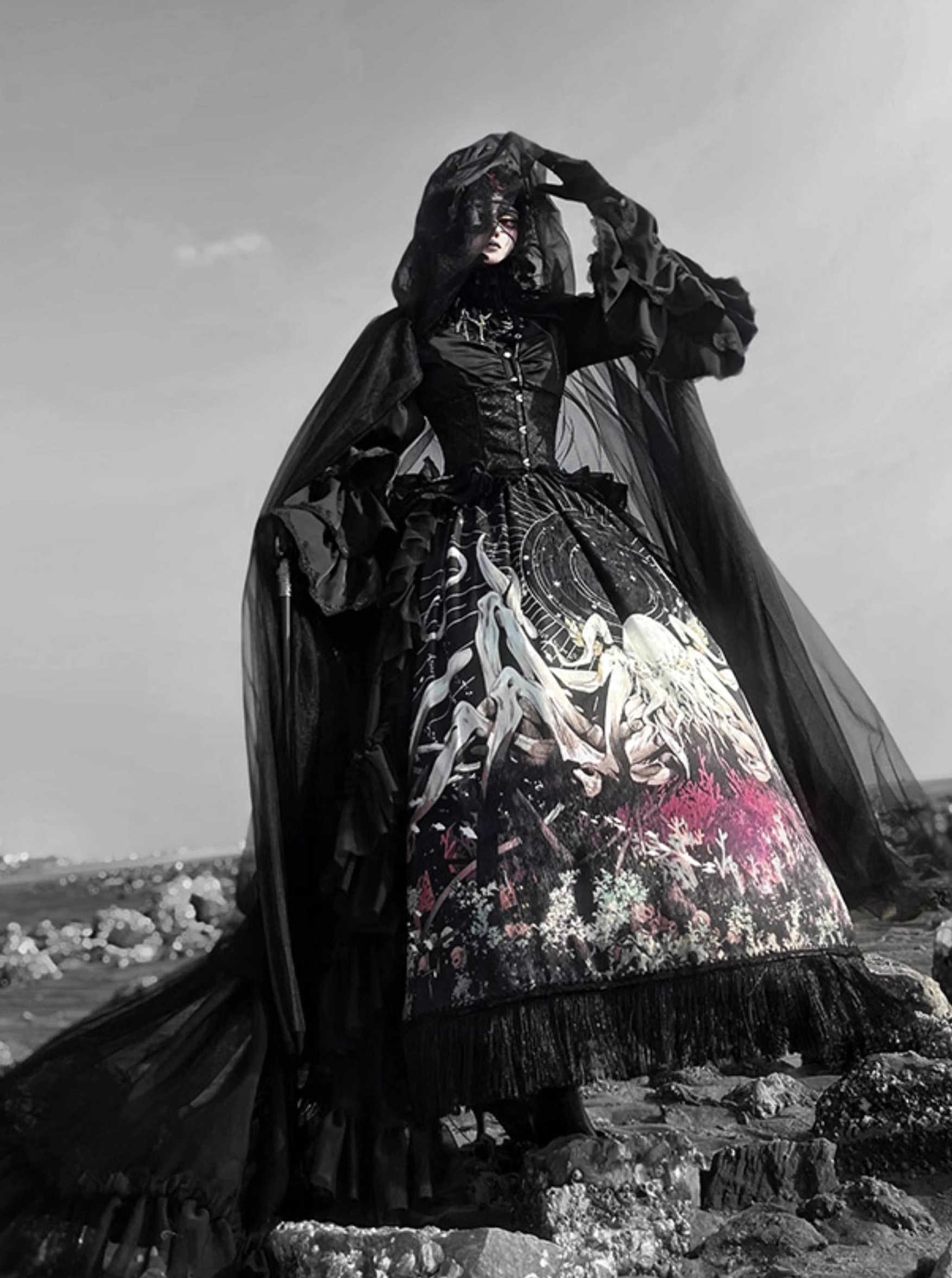 Hooded black Cthulhu Gothic Lolita dress low angle full body front view corset bodice matching hooded sheer cape octopus print skirt frayed hem