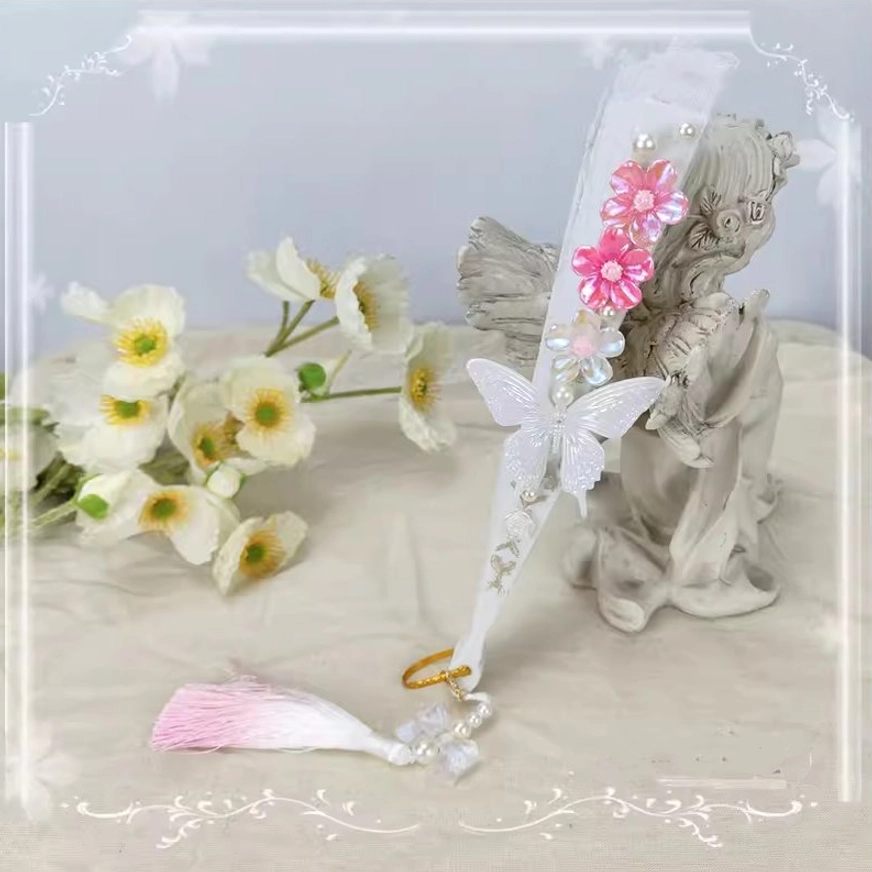 Closed lolita folding fan side profile featuring hot pink flower decoration white butterfly ornament and pink-white gradient tassel with pearl bead pendant