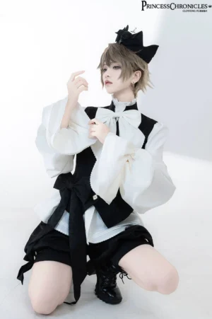 Half-body kneeling shot of vintage Ouji blouse with detachable white bow tie and structured tailored waistcoat featuring decorative buttons